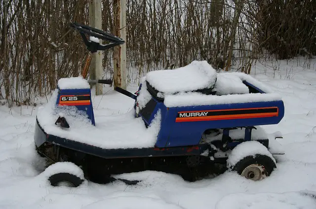 Riding mower sitting in snow