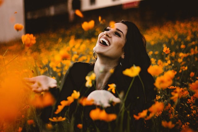 woman showered with orange flowers of love